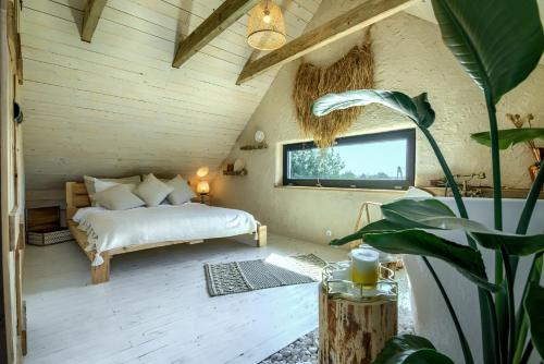 a bedroom with a bed and a tv on the wall at Pod mazurskim niebem dom rustykalny in Piecki