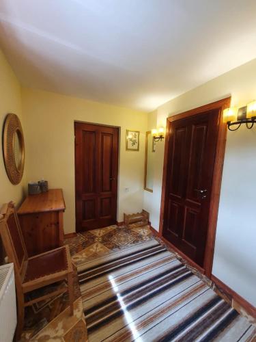 a room with wooden doors and a wooden floor at Rakši in Cēsis