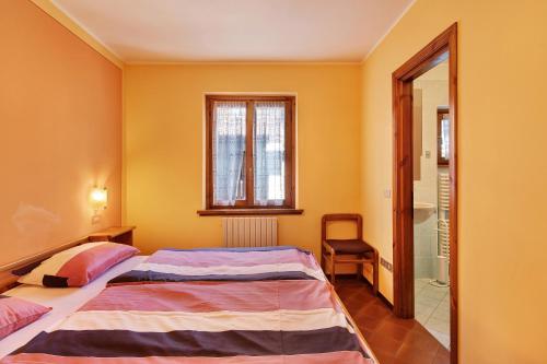Ένα ή περισσότερα κρεβάτια σε δωμάτιο στο Chalet Meridiana Appartamento 7