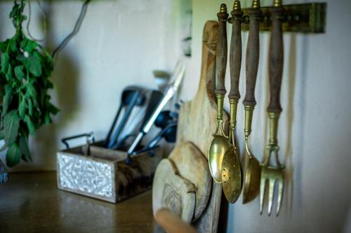 a group of kitchen utensils hanging on a wall at Pod mazurskim niebem dom rustykalny in Piecki