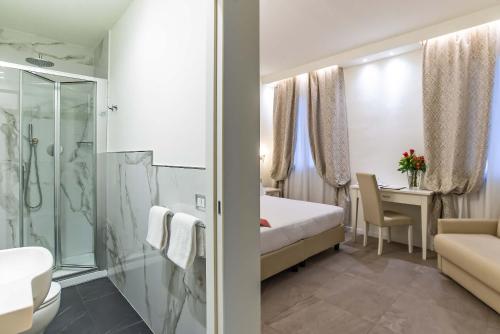 a hotel room with a bed and a bathroom at Hotel Accademia in Florence