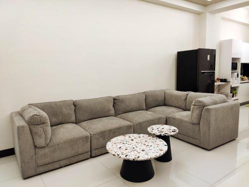 a living room with a couch and two tables at Lin's B&B in Pingtung City
