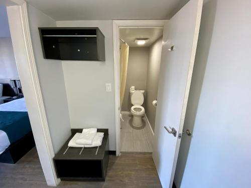 a room with a bathroom with a toilet and a television at Motel 6 Bonne Terre, MO in Bonne Terre