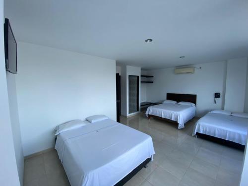 Una cama o camas en una habitación de Hotel Torres del Llano