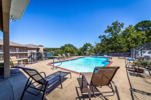 a patio with chairs and a swimming pool at Beautiful Lakefront Condo 2 En Suite BRs in Hot Springs
