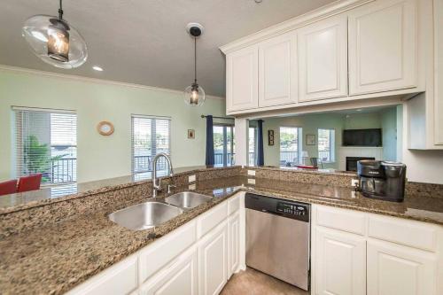 a kitchen with white cabinets and a sink at Beautiful Lakefront Condo 2 En Suite BRs in Hot Springs