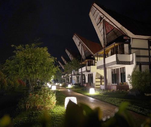 a row of houses at night with lights at Toraja Misiliana Hotel in Rantepao