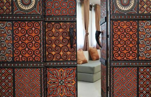 a pair of doors with patterns on them in a room at Toraja Misiliana Hotel in Rantepao