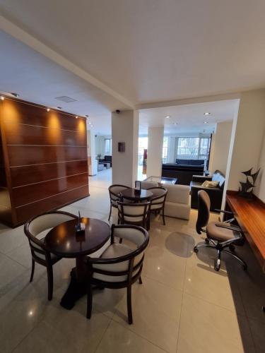 a lobby with tables and chairs and a couch at Villaggio Hotel Boutique in Mendoza