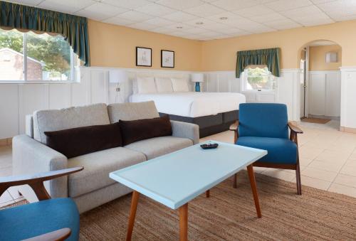 a living room with a couch and a bed at Breezeway Boutique Hotel in Westerly