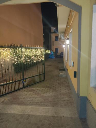 a hallway with a fence with christmas lights at Hotel al Corso in Legnano