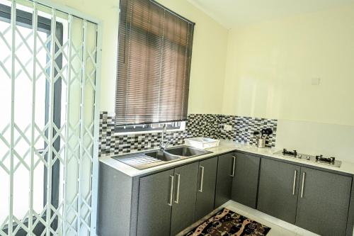 a kitchen with a sink and a window at New Villa Geranium in Grand Baie