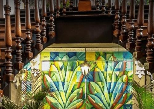 a staircase with a colorful mural on the wall at Mexico Hostel in Mexico City