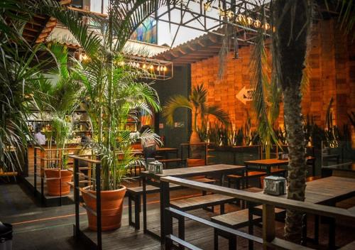 a restaurant with tables and potted plants in it at Mexico Hostel in Mexico City