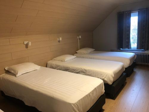 Postel nebo postele na pokoji v ubytování Hotel Oude Abdij