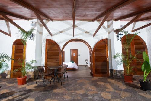 a room with a table and chairs and a bed at Apu Samay Nature Lodge in Tarapoto