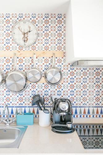 a kitchen with blue and white tiles on the wall at Casa Monte do Cervo in Vila Nova de Cerveira