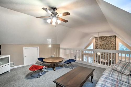 a living room with a ceiling fan and a table at Lake Hartwell Home with Private Dock and Hot Tub! in Lavonia