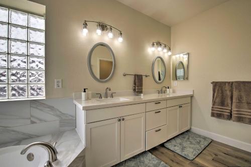 a bathroom with two sinks and a tub and mirrors at Gilbert Group Getaway 3 Mi to Dtwn in Gilbert