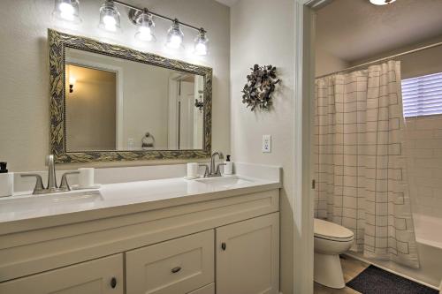 a bathroom with a sink and a toilet and a mirror at Gilbert Group Getaway 3 Mi to Dtwn in Gilbert