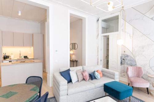 The Lift Apartments by RIDAN Hotels في لشبونة: غرفة معيشة مع أريكة وطاولة