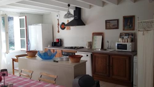 a kitchen with a sink and a stove top oven at La Godelière in La Chaussée