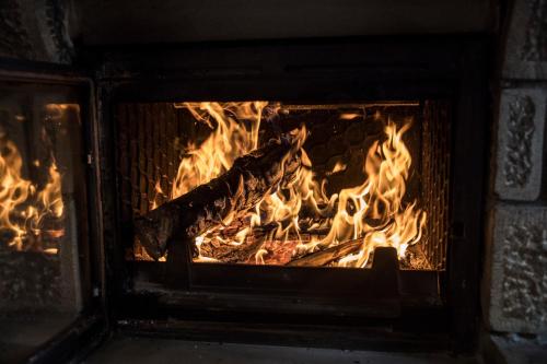 a fire in a brick oven with flames at Archontiko Tsiboni in Elati Trikalon