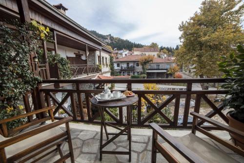 a balcony with a table and chairs and a view at Archontiko Tsiboni in Elati Trikalon