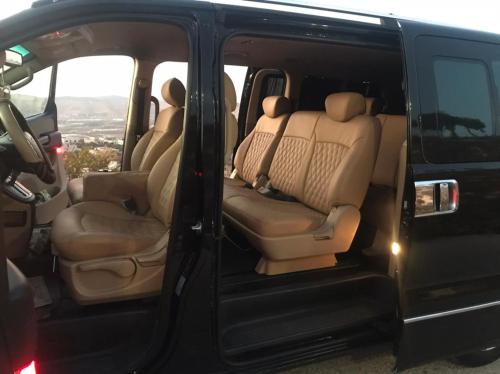 a black van with the doors open with the back seats at باص سياحي مع سائق و دليل سياحي متخصص in Al Qasţal