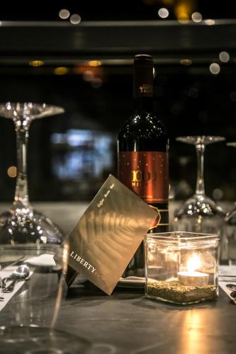 a bottle of wine and a candle on a table at Liberty of Nafplio in Nafplio