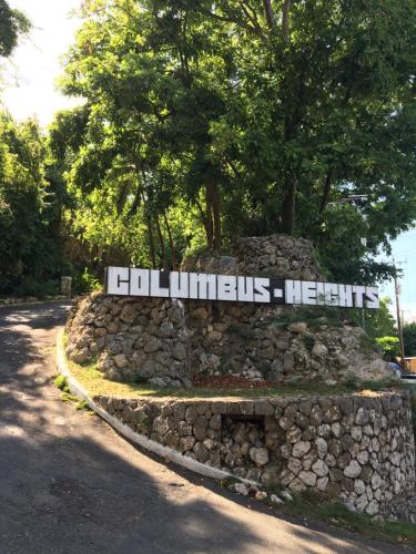 a stone wall with a sign on top of it at Immaculate 1-Bed Villa in Ocho Rios in Ocho Rios
