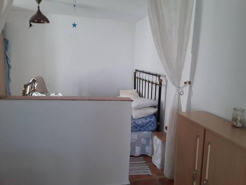 a small bedroom with a bed and a curtain at 2-Bed Apartment - Sleeps 3 - Parking - near Albox in Albox