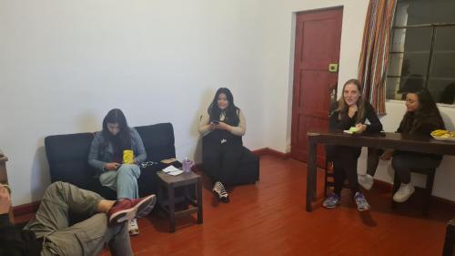 a group of women sitting in a room at SK Hostal in Cusco