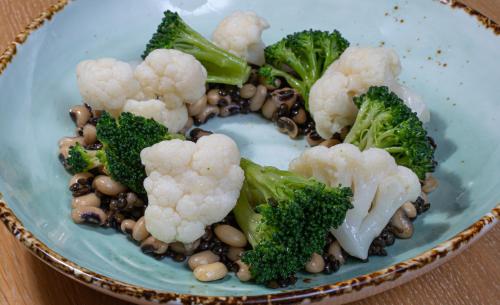 a plate of broccoli and beans on a table at Pantelidis Hotel & Spa in Ptolemaida