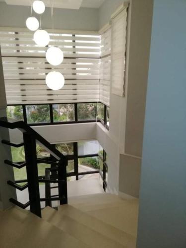 a room with a staircase and a window with blinds at Luxury Villa at Mariveles Bataan Philippines Ph in Mariveles