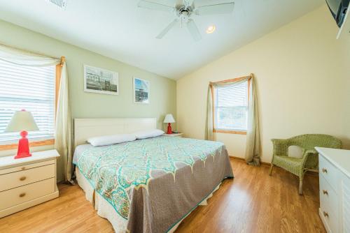 a bedroom with a bed and a ceiling fan at Lost Shaker of Salt in Whalebone