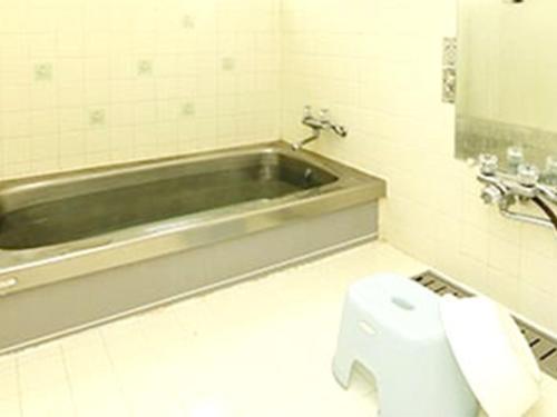 a bathroom with a toilet and a bath tub at Blanche Mori - Vacation STAY 86844v in Hokuto
