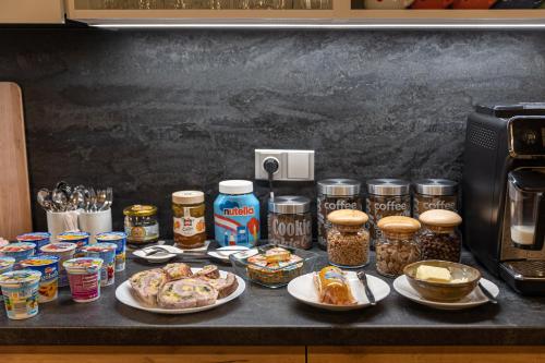 a counter topped with plates of food and canned goods at U Komárků in Špindlerův Mlýn