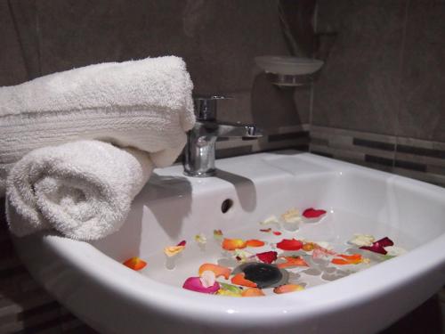 a white bathroom sink filled with lots of debris at Hôtel Zahrat Souss -Inezgane in Inezgane