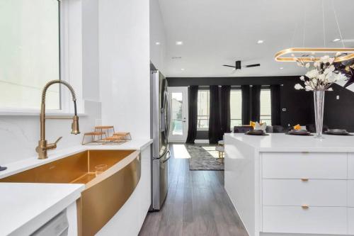 a kitchen with white counters and a large sink at The Suite Spot! Downtown Skyline Views! Sleeps 12 in Houston