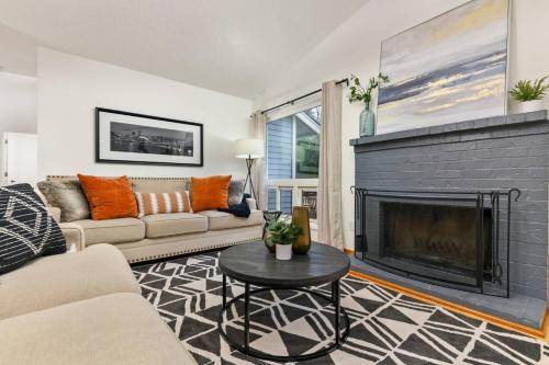a living room with a couch and a fireplace at Tanner Basin Retreat in West Linn