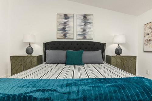 a bedroom with a large bed with a blue blanket at Tanner Basin Retreat in West Linn