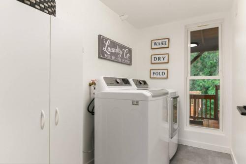 a small refrigerator in a kitchen with a sign on the wall at Tanner Basin Retreat in West Linn