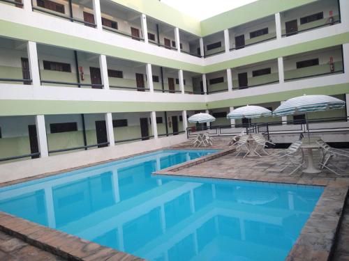 a swimming pool in the middle of a building at Victor's Center Hotel in Guarabira