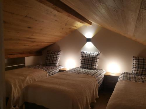a attic room with two beds and two lights at Kaban' des neiges in Saint-Gervais-les-Bains
