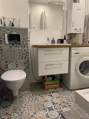 a bathroom with a sink and a washing machine at Brzeźno plaża in Gdańsk