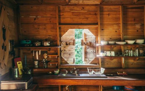 a kitchen with a sink and a window at ENSUEÑOS Natural Reserve Big House in Little Corn Island