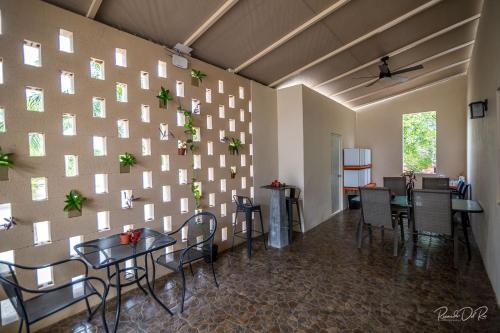 a wall with tables and chairs in a room at Azcapri Villa Boutique & Spa in Cancún