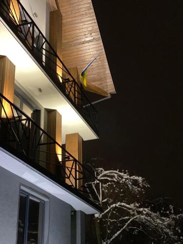 a bird sitting on the side of a building with stairs at Girske Povitria 2 in Yaremche