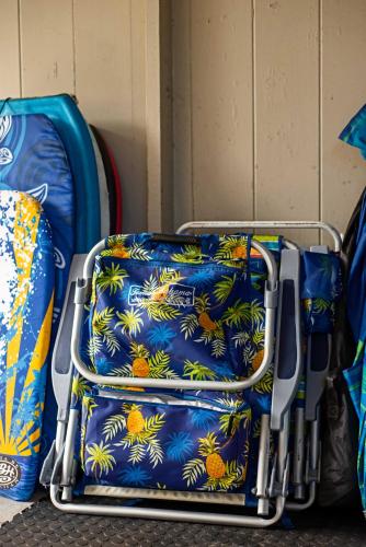 a luggage cart with a blue shirt with oranges and pineapple at Hale Leilani - Hilo 3BR cold AC in Hilo